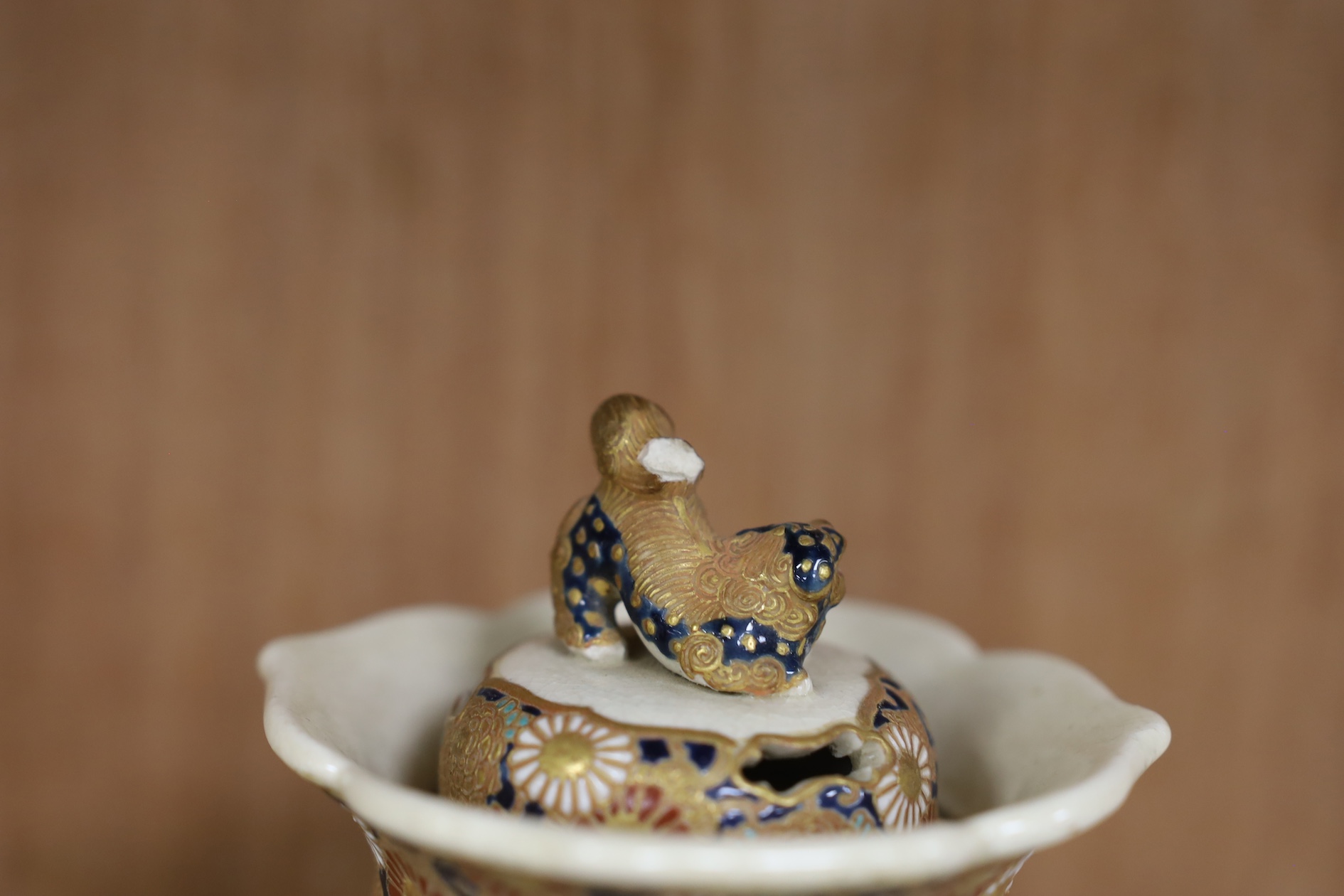 A late 19th century Japanese Satsuma ‘hundred antiques’ gosu blue pot pourri vase and three later items of Satsuma, including a bowl and cover a bowl on stand, a box and cover, tallest 18.5cm high. Condition - vase cover